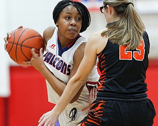 Fitch's Daria Williams looks to pass the ball while Howland's Makayla Dahman tries to block her during the first half of their game at Fitch High School on Wednesday night. EMILY MATTHEWS | THE VINDICATOR