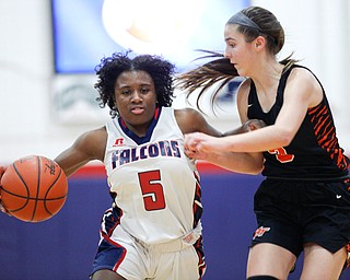 Fitch's Jada Lazaro dribbles the ball while Howland's Ashley Chambers tries to block her during the first half of their game at Fitch High School on Wednesday night. EMILY MATTHEWS | THE VINDICATOR