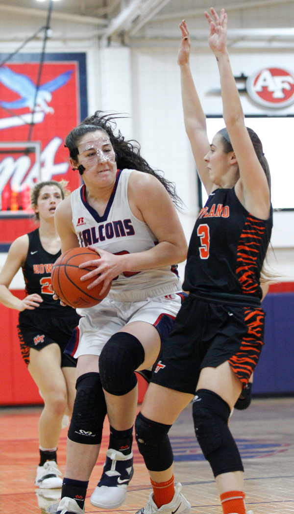 Fitch's Sabria Hunter advances toward the hoop while Howland's Ashley Chambers tries to block her during the first half of their game at Fitch High School on Wednesday night. EMILY MATTHEWS | THE VINDICATOR