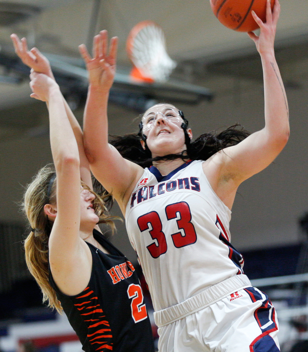 Fitch's Sabria Hunter goes for a basket while Howland's Alex Ochman tries to block her during the first half of their game at Fitch High School on Wednesday night. EMILY MATTHEWS | THE VINDICATOR
