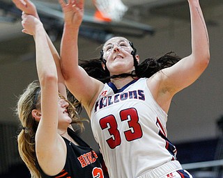 Fitch's Sabria Hunter goes for a basket while Howland's Alex Ochman tries to block her during the first half of their game at Fitch High School on Wednesday night. EMILY MATTHEWS | THE VINDICATOR