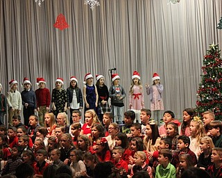 Neighbors | Abby Slanker.Second-grade students at Hilltop Elementary School wore Santa hats as they presented Holidays Around the World on Dec. 18.
