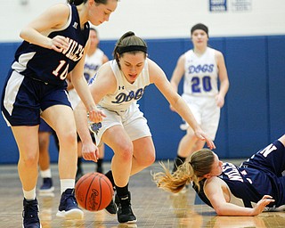 Poland's Kat Partika and Niles' Brandi Baker, left, go after the ball after Niles' Lindsay Hayes, right, falls during their game at Poland on Thursday. EMILY MATTHEWS | THE VINDICATOR