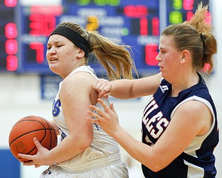 Poland's Mia Gajdos goes towards the hoop while Niles' Lindsay Hayes tries to block her during their game at Poland on Thursday. EMILY MATTHEWS | THE VINDICATOR