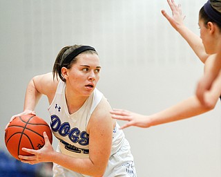 Poland's Kat Partika looks to pass the ball while Niles' Kayla Taylor-Hall tries to block her during their game at Poland on Thursday. EMILY MATTHEWS | THE VINDICATOR