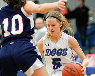 Poland's Ella Harrell dribbles the ball while Niles' Brandi Baker tries to block her during their game at Poland on Thursday. EMILY MATTHEWS | THE VINDICATOR