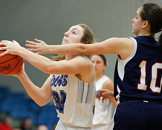 Poland's Morgan Kluchar looks towards the hoop while Niles' Brandi Baker tries to block her during their game at Poland on Thursday. EMILY MATTHEWS | THE VINDICATOR