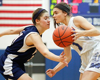 Poland's Brooke Bobbey dribbles the ball while Niles' Kayla Taylor-Hall tries to block her during their game at Poland on Thursday. EMILY MATTHEWS | THE VINDICATOR