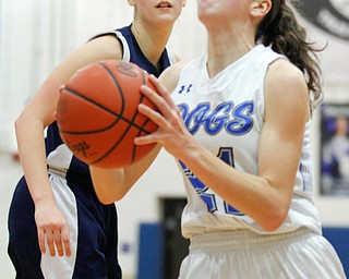 Poland's Jackie Grisdale looks towards the hoop while Niles' Kayla Taylor-Hall looks on during their game at Poland on Thursday. EMILY MATTHEWS | THE VINDICATOR