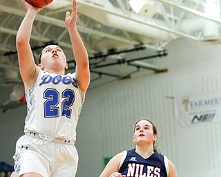 Poland's Kat Partika goes for the basket while Niles' Megan Blank runs up behind her during their game at Poland on Thursday. EMILY MATTHEWS | THE VINDICATOR