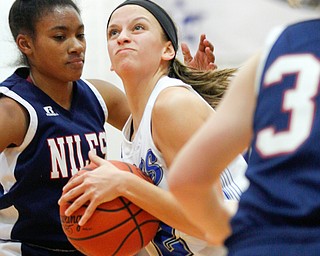 Poland's Sarah Bury looks towards the hoop while Niles' Aneziah Fryer, left, and Lindsay Hayes, right, try to block her during their game at Poland on Thursday. EMILY MATTHEWS | THE VINDICATOR