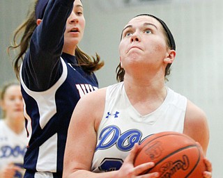 Poland's Kat Partika looks towards the hoop while Niles' Emma Flanigan tries to block her during their game at Poland on Thursday. EMILY MATTHEWS | THE VINDICATOR