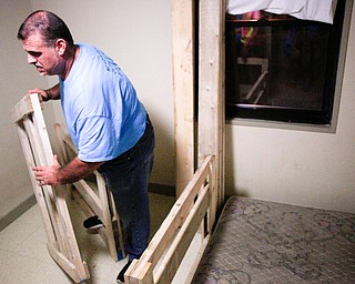 Dane "Mickey" Carder, of Canfield, helps put together a bunk bed in a Campbell home with Sleep in Heavenly Peace on Saturday evening. Sleep in Heavenly Peace spent the day constructing the pieces of the bed and then took those pieces and built the bed in the home of a family who needed the bed. This was Sleep in Heavenly Peace's first build and delivery, but they said they have over 70 more requests for bunk beds in the area.