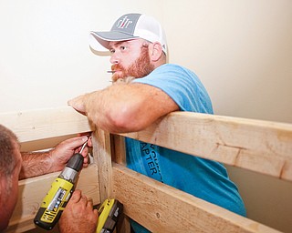 Travis Leonard, of Austintown, and Dane "Mickey" Carder help put together a bunk bed they're building in a Campbell home with Sleep in Heavenly Peace on Saturday evening. Sleep in Heavenly Peace spent the day constructing the pieces of the bed and then took those pieces and built the bed in the home of a family who needed the bed. This was Sleep in Heavenly Peace's first build and delivery, but they said they have over 70 more requests for bunk beds in the area.