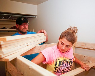 Jeff Watkins, left, of Cornersburg, and Meredith Eversole, 17, of Salem, help put together a bunk bed they're building in a Campbell home with Sleep in Heavenly Peace on Saturday evening. Sleep in Heavenly Peace spent the day constructing the pieces of the bed and then took those pieces and built the bed in the home of a family who needed the bed. This was Sleep in Heavenly Peace's first build and delivery, but they said they have over 70 more requests for bunk beds in the area.