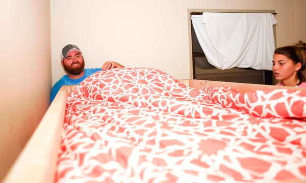 Travis Leonard, left, of Austintown, and Meredith Eversole, 17, of Salem, put sheets on a bunk bed they helped build with Sleep in Heavenly Peace on Saturday evening. Sleep in Heavenly Peace spent the day constructing the pieces of the bed and then took those pieces and built the bed in the home of a family who needed the bed. This was Sleep in Heavenly Peace's first build and delivery, but they said they have over 70 more requests for bunk beds in the area.