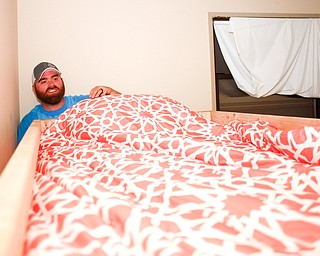 Travis Leonard, left, of Austintown, and Meredith Eversole, 17, of Salem, put sheets on a bunk bed they helped build with Sleep in Heavenly Peace on Saturday evening. Sleep in Heavenly Peace spent the day constructing the pieces of the bed and then took those pieces and built the bed in the home of a family who needed the bed. This was Sleep in Heavenly Peace's first build and delivery, but they said they have over 70 more requests for bunk beds in the area.