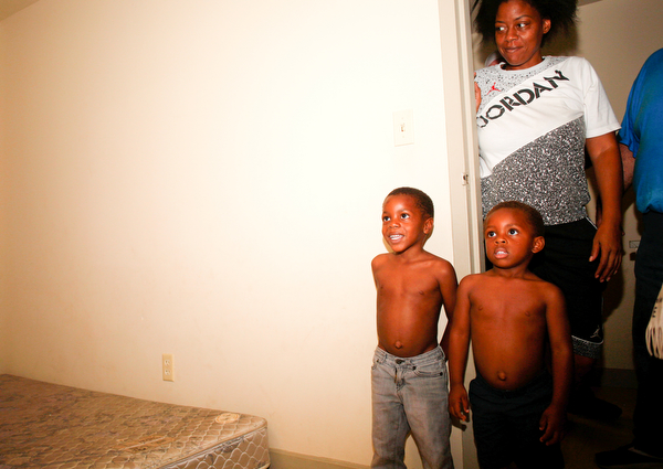 Zion Johnson, 4, left, Xyayion Dotson, 3, and their mother Jawan Murray look at the new bunk bed Sleep in Heavenly Peace provided and built in their home in Campbell on Saturday night. Prior to receiving the bunk bed, the three children in the family were sharing one mattress.