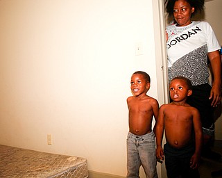 Zion Johnson, 4, left, Xyayion Dotson, 3, and their mother Jawan Murray look at the new bunk bed Sleep in Heavenly Peace provided and built in their home in Campbell on Saturday night. Prior to receiving the bunk bed, the three children in the family were sharing one mattress.