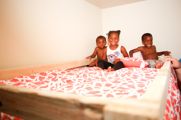 From left, Xyayion Dotson, 3, Miracle Morgan, 5, and Zion Johnson, 4, sit in the top bunk of their new bunk bed from Sleep in Heavenly Peace in their home in Campbell on Saturday night. Prior to receiving the bunk bed, the three children were sharing one mattress.