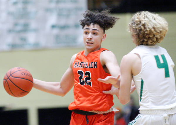 Massillon's Jaiden Wise dribbles the ball while Ursuline's Vince Armeni tries to block him during their game at Ursuline on Friday night. EMILY MATTHEWS | THE VINDICATOR