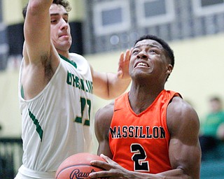 Massillon's Kyshad Mack looks towards the net while Ursuline's Luke Pipala tries to block him during their game at Ursuline on Friday night. EMILY MATTHEWS | THE VINDICATOR