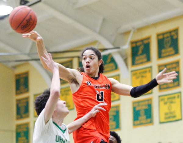 Massillon's Jayden Ballard passes the ball while Ursuline's Pat McLaughlin tries to block him during their game at Ursuline on Friday night. EMILY MATTHEWS | THE VINDICATOR