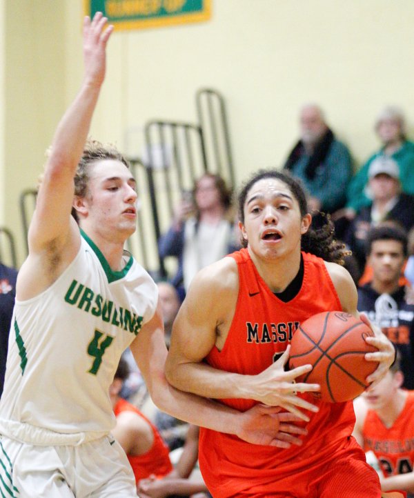 Massillon's Jayden Ballard drives the ball while Ursuline's Vince Armeni tries to block him during their game at Ursuline on Friday night. EMILY MATTHEWS | THE VINDICATOR