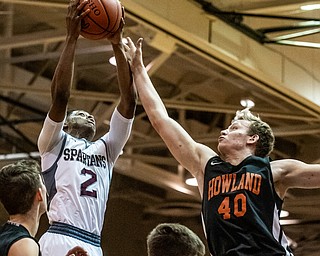 DIANNA OATRIDGE | THE VINDICATOR Boardman's Che Trevena (2) puts up a shot against Howland's Nathan Barrett (40) during the Spartans' 73-42 victory on their home court Friday night.