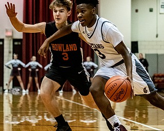 DIANNA OATRIDGE | THE VINDICATOR Boardman's Derrick Anderson (3) drives around Howland's Jordan Sperling (3) during the Spartans' 73-42 win in Boardman on Friday night.