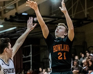 DIANNA OATRIDGE | THE VINDICATOR Howland's Frankie Manios (21) puts up a 3-point shot as Boardman's Shay Eicher (20) defends during the Spartans' 73-42 victory in Boardman on Friday night.