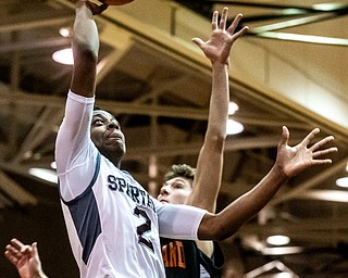 DIANNA OATRIDGE | THE VINDICATOR  Boardman's Che Trevena (2) shoots a floater over Howland defender Cam Durig (15) during the Spartans' 73-42 victory in Boardman on Friday night.