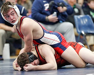 Austintown Fitch's Zach Richards, top, and Girard's Alex Delgarbino wrestle during the EOWL wrestling finals at Austintown Fitch High School on Saturday afternoon. Richards placed first in the 132 weight class. EMILY MATTHEWS | THE VINDICATOR