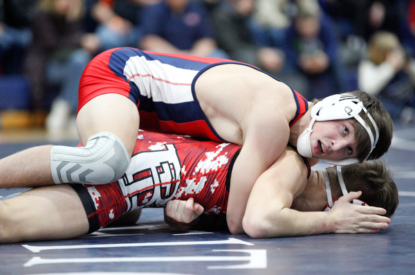 Austintown Fitch's Gus Sutton and Beaver Local's Jared Wright at the EOWL wrestling finals at Austintown Fitch High School on Saturday afternoon. EMILY MATTHEWS | THE VINDICATOR