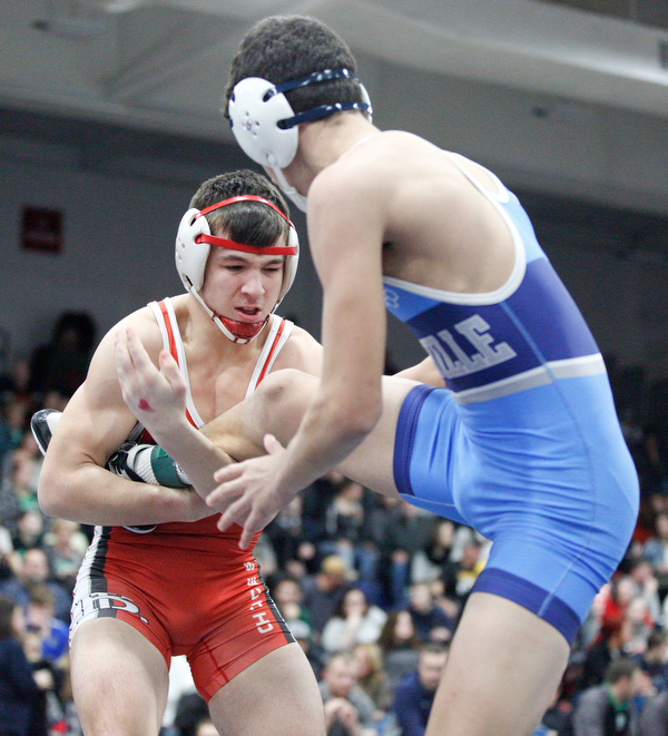 Beaver Local's Skyler Lasure and Louisville's Daniel Kennedy at the EOWL wrestling finals at Austintown Fitch High School on Saturday afternoon. EMILY MATTHEWS | THE VINDICATOR