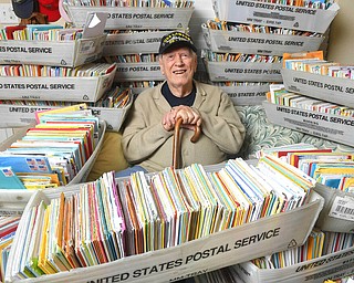 In this Tuesday, Jan. 8, 2019, photo, Duane Sherman, 96, poses at home with a small fraction of the 50,000 birthday cards he's received after his daughter's social media request for people to send him cards to cheer him up on his birthday went viral in Fullerton, Calif.