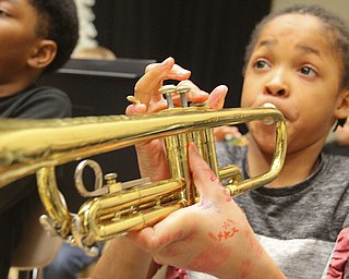 Paul C. Bunn fifth-grader Terry Luckey plays the  trumpet in the school band  during a rehearsal. Youngstown schools have expanded musical opportunities for young students.