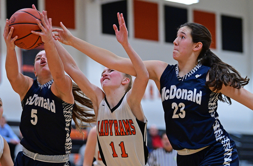 MINERAL RIDGE, OHIO - JANUARY 2019: McDonald's Lucy Wolford, left, grabs a rebound away from Mineral Ridge's Lizzy Panic and teammate Sophia Costantinio during the second half of their game, Monday night at Mineral Ridge High School. McDonald won 46-18. DAVID DERMER | THE VINDICATOR