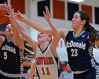 MINERAL RIDGE, OHIO - JANUARY 2019: McDonald's Lucy Wolford, left, grabs a rebound away from Mineral Ridge's Lizzy Panic and teammate Sophia Costantinio during the second half of their game, Monday night at Mineral Ridge High School. McDonald won 46-18. DAVID DERMER | THE VINDICATOR