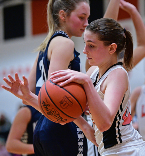 MINERAL RIDGE, OHIO - JANUARY 2019: Mineral Ridge's Fran Kesner dribbles with the ball after taking it away from McDonald's Maddy Howard during the second half of their game, Monday night at Mineral Ridge High School. McDonald won 46-18. DAVID DERMER | THE VINDICATOR