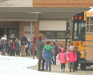 Children file out of Market Street Elementary in Boardman and onto buses at the end of their school day. The school district has proposed closing Market, one of its four elementary schools, at the end of the school year. 