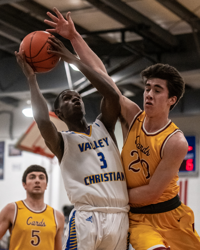 DIANNA OATRIDGE | THE VINDICATOR  Valley Christian's Damon Christian (3) tries to put up a shot against the defense of Mooney's Matt Brennan (20) during the Eagles' 58-56 victory in Youngstown on Tuesday. Mooney's Pete Haas (5) looks on.