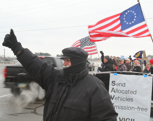William D. Lewis The Vindicator Werner Lange waves at passing motorists during  vigil outside the GM Lordstown plant 1-16-19. Lange has been holding a vigil outside the plant the announcement came of plant closing.