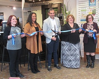 Neighbors | Jessica Harker.Pressed Coffee bar and Eatery celebrated the official opening on the new location in the Poland library on Jan. 10 with a ribbon cutting ceremony where representatives, from left, Megan Shaw, Amy Tuscano, Frank Tuscano, Pamela Vonbergen and Aimee Fifarek, prepared to cut the ribbon.
