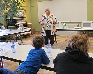 Neighbors | Jessica Harker.Children listened as educator Lynn Zocolo explained the experiments the children would be doing during the Sprout Club's mad science event on Dec. 13.