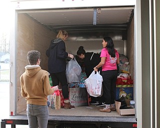Neighbors | Abby Slanker.Canfield High School student council members loaded gifts that were collected at the school for the Salvation Army Angel Tag Drive on the Salvation Army truck destined for the distribution center on Dec. 12.