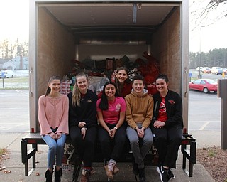 Neighbors | Abby Slanker.Canfield High School student council members, from left, Claire Berlin, Alyssa Householder, Fiona Lally, Clare Crescimanno, Zach Russo and Jill Mt. Castle loaded more than 200 items donated from the school onto the Salvation Army truck as part of the Salvation Army Angel Tag Drive on Dec. 12.