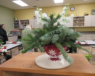 Neighbors | Jessica Harker.Marie Borocz created a finished version of the holiday centerpiece being taught in her class at Fellows Riverside Garden.