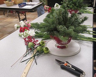 Neighbors | Jessica Harker.Community members were given a vase with fresh evergreen, other live plants and holiday decorations to complete their own unique holiday centerpiece on Dec. 18.