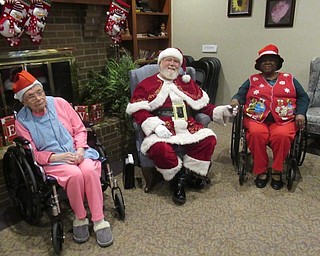 Neighbors | Jessica Harker.Beeghly Oaks residents Helen Horkey and Jean White posed with Santa Claus at the buildings annual holiday party on Dec. 19.